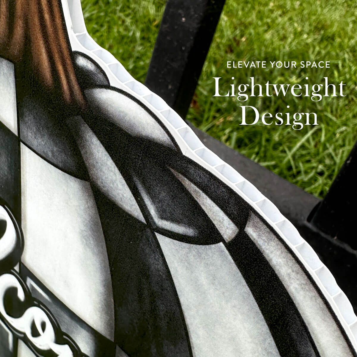 Close-up of a black and white striped pumpkin with grass in the background and text 'Elevate Your Space Lightweight Design'.