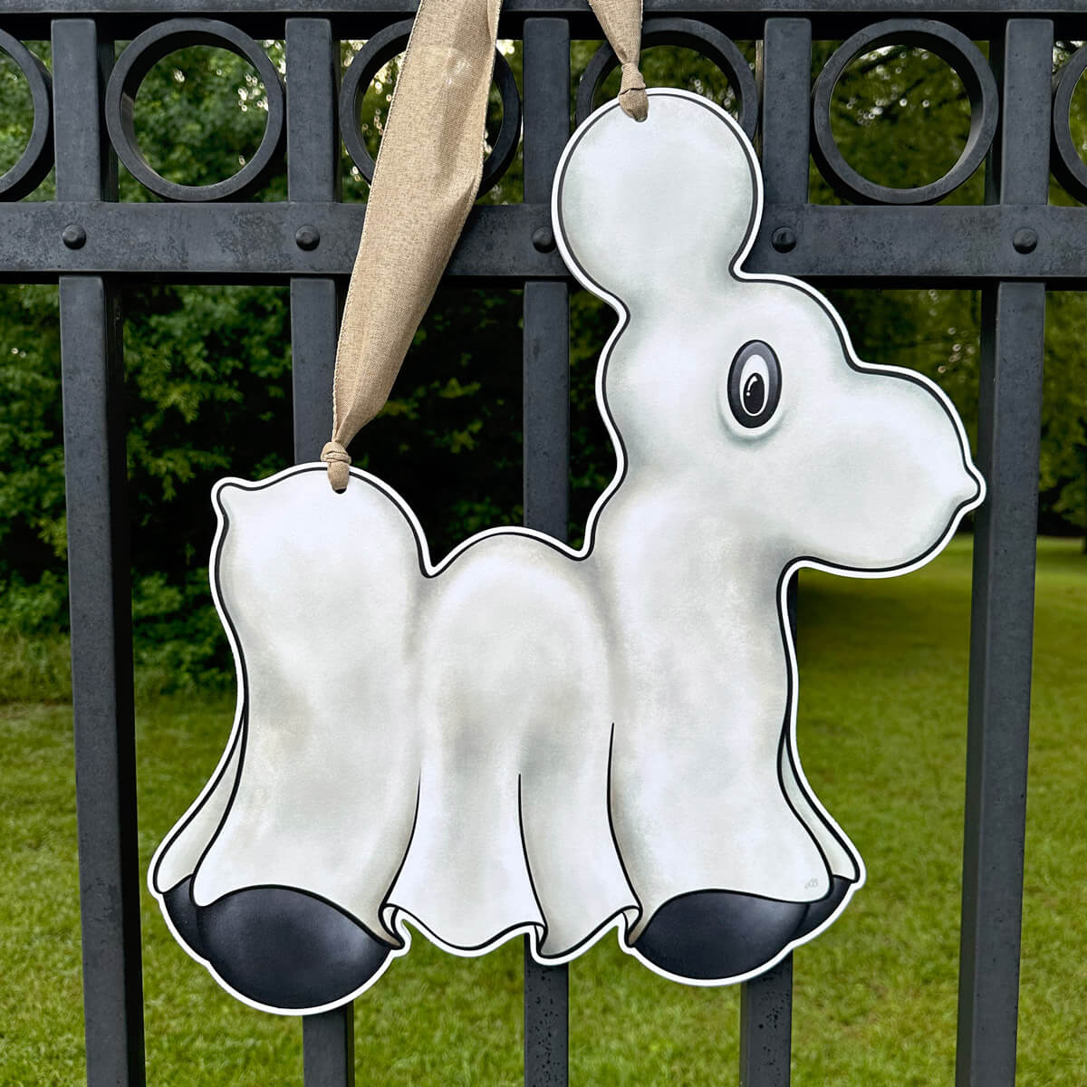 Decorative Halloween Ghost Bead Dog Door Hanger with black accents hanging on a black metal fence.