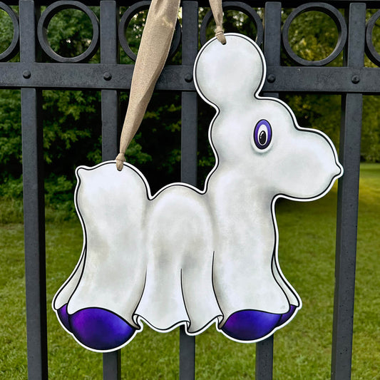 Decorative Halloween Ghost Bead Dog ghost door hanger with purple accents hanging on a black metal fence.