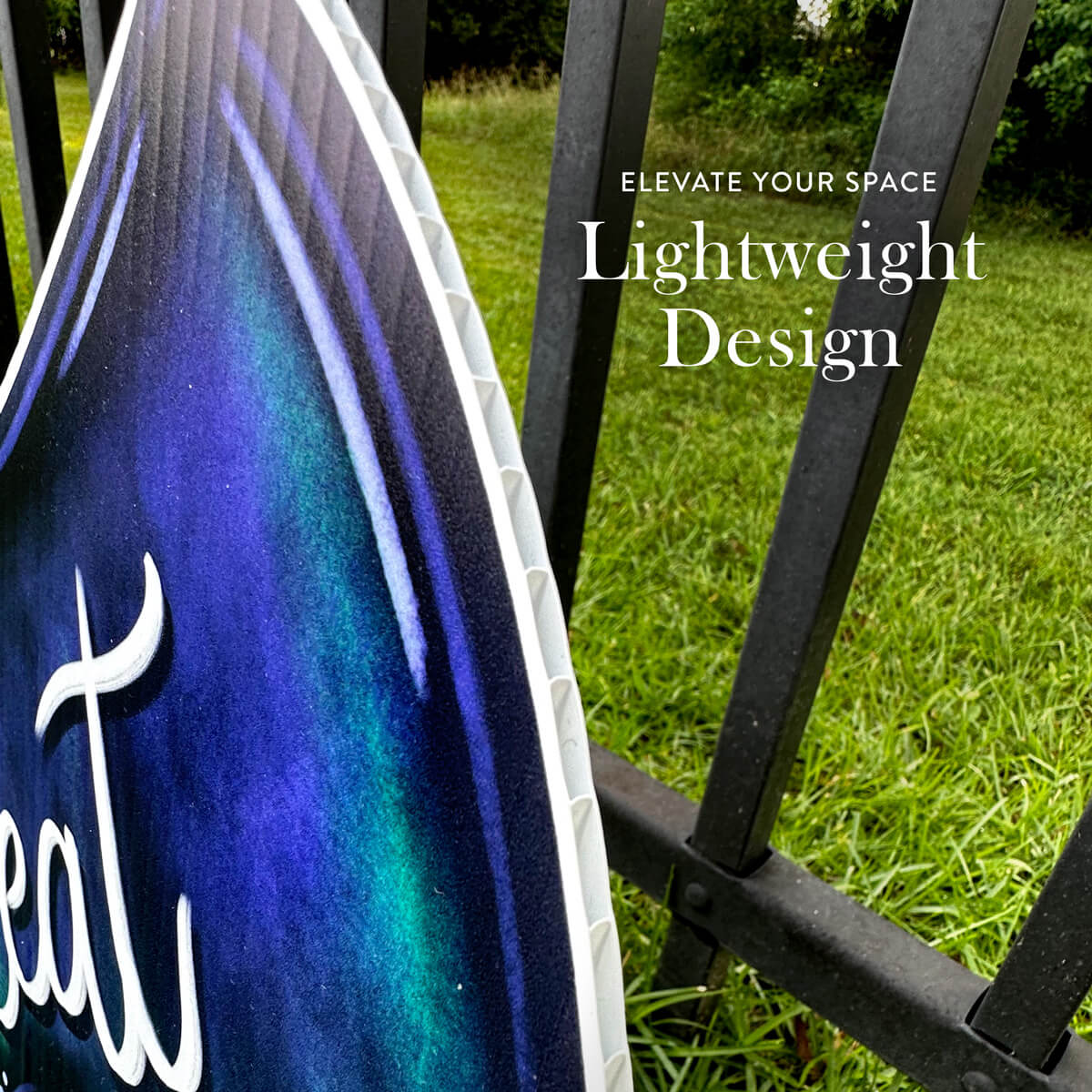 Decorative Halloween bat sign with colorful design and text 'Elevate Your Space' on grass background