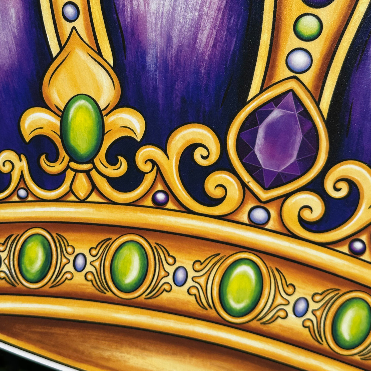 Close-up of a gold crown with green and purple gemstones on a dark background